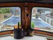 Jonge Jan's cabin with solar panels, firewood bucket, and horn.