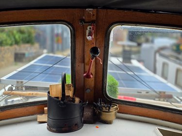 Jonge Jan's cabin with solar panels, firewood bucket, and horn.